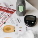 Glucometer and diabetes documents on a table for health monitoring.